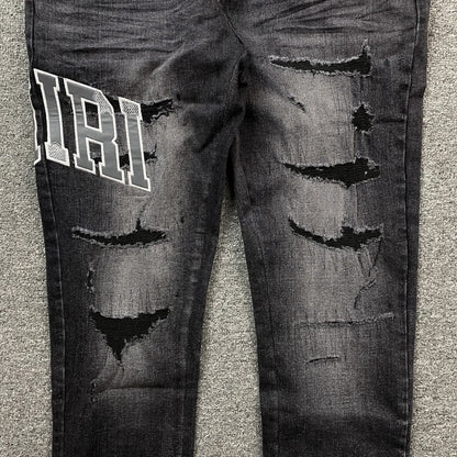 AMIRI VARSITY LOGO REPAIR JEANS
